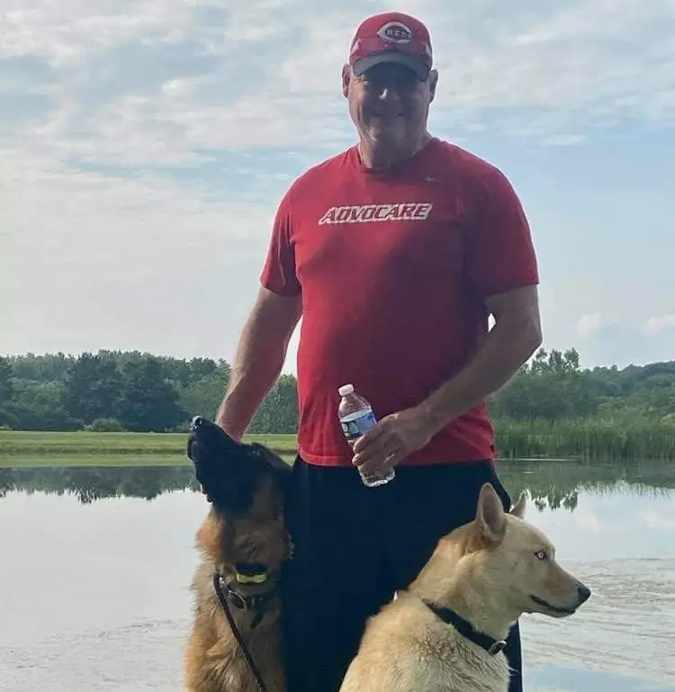 Tony Tipton with his dogs by the lake