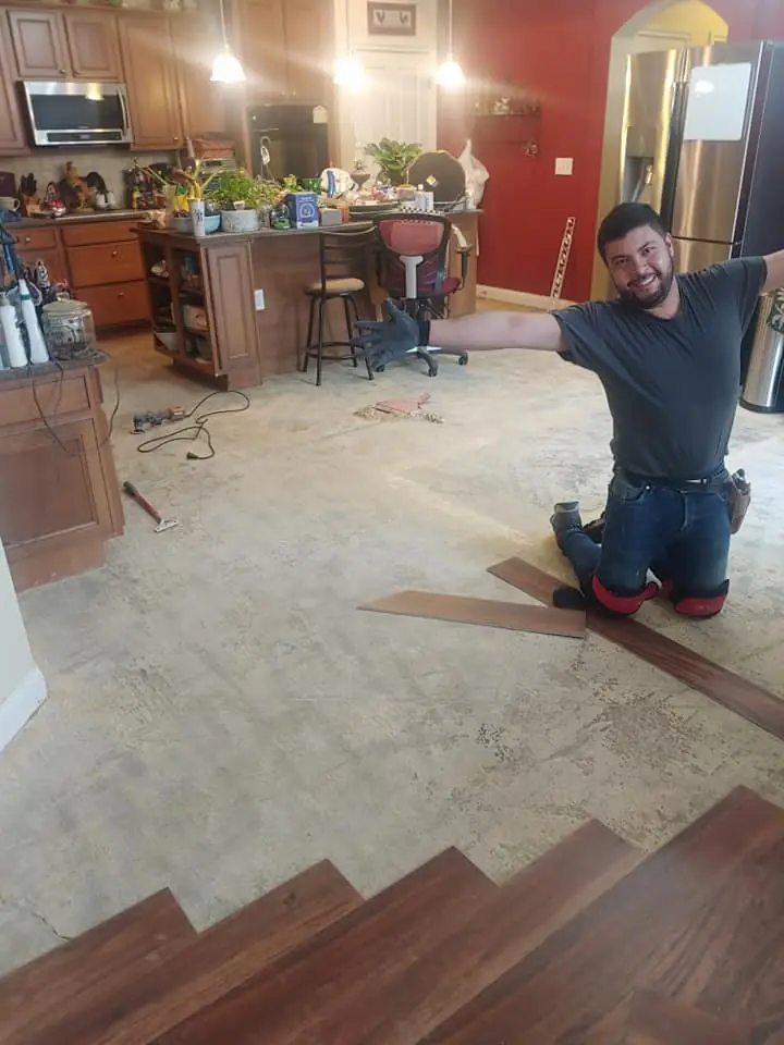 Tony mid-install laying LVT flooring