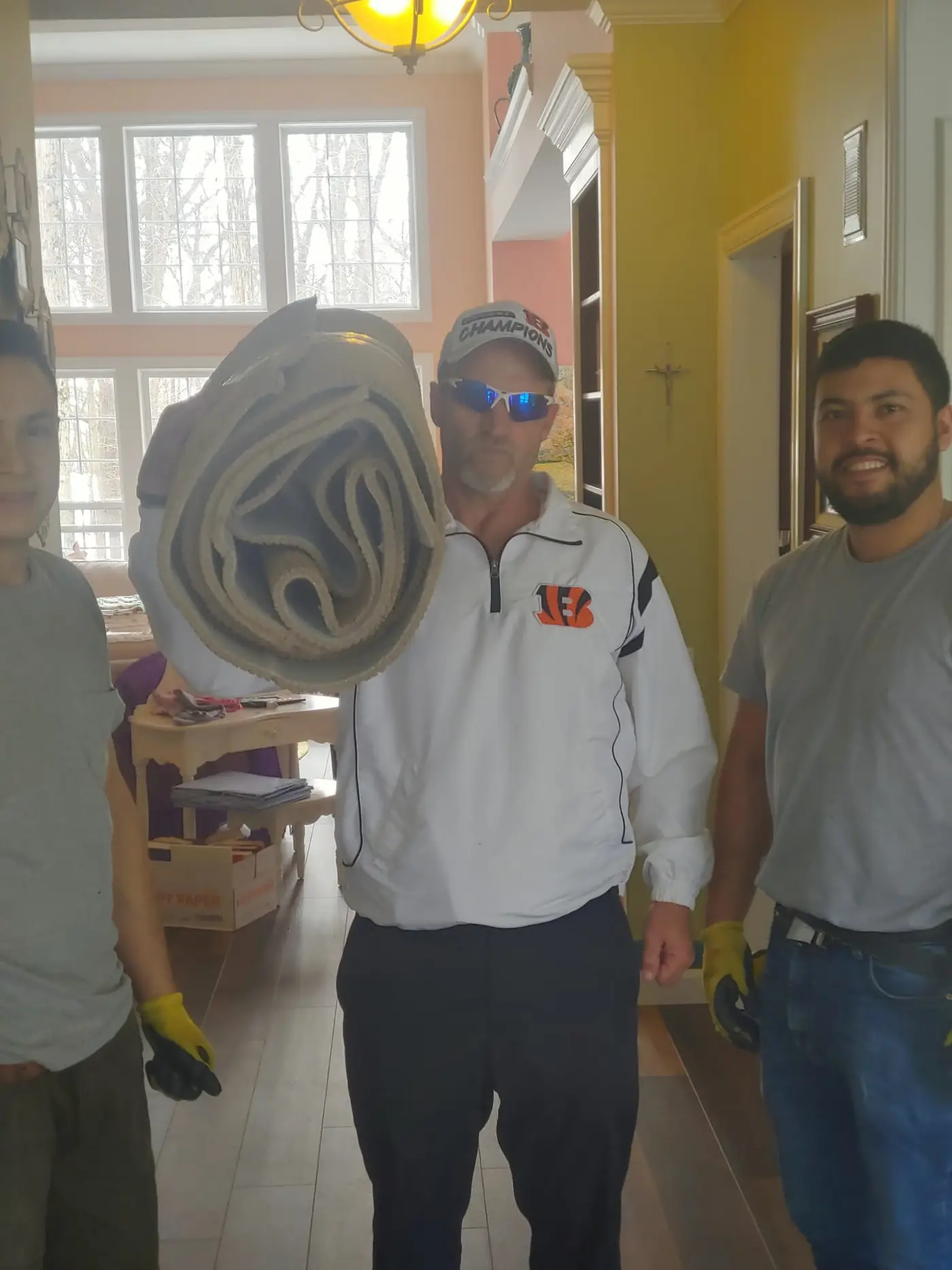 The crew hauling out old carpet before a fresh install