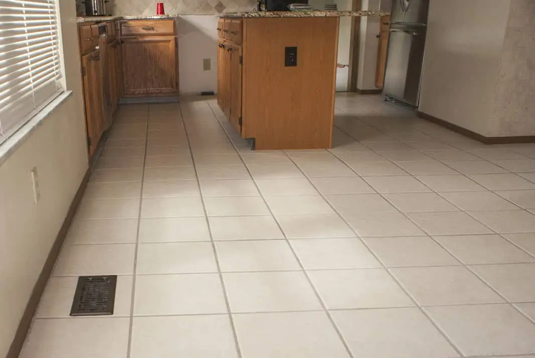 Kitchen with old cream ceramic tile before LVT installation